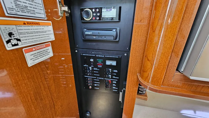 Slide: The Image of Control panel of 2013 Sea Ray 280 Sundancer with audio system and warning labels. - 28