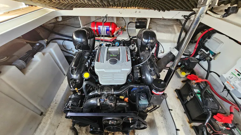 Slide: The Image of Engine compartment of a 2013 Sea Ray 280 Sundancer boat, featuring a well-maintained engine. - 29