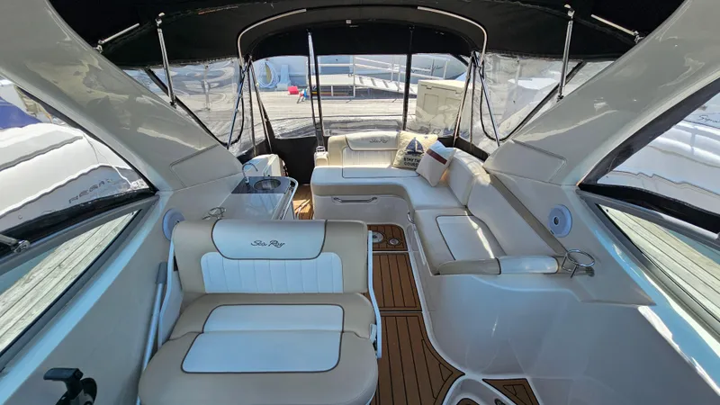 Slide: The Image of 2013 Sea Ray 280 Sundancer interior with white seating and wood flooring. - 6