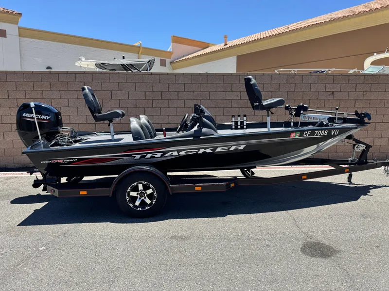The Image of 2021 Tracker Pro Team 175 TXW boat on trailer, parked outdoors. - 0
