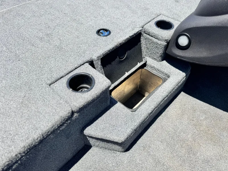 Slide: The Image of 2021 Tracker Pro Team 175 TXW boat interior with storage compartment and cup holders. - 16