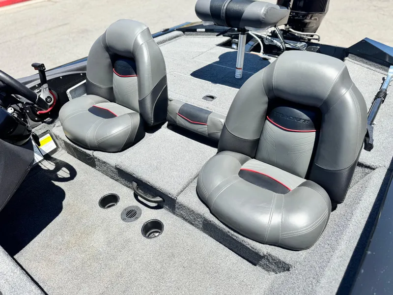Slide: The Image of 2021 Tracker Pro Team 175 TXW boat interior with gray seating and steering console. - 17