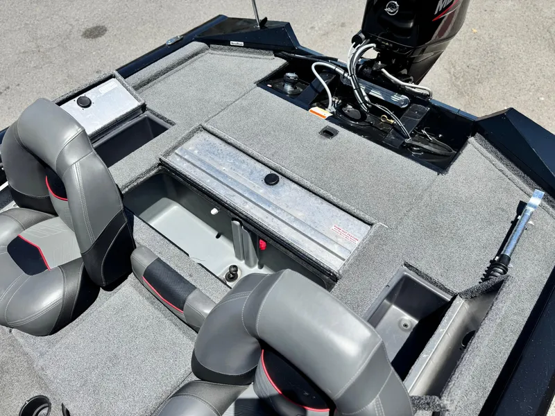 Slide: The Image of 2021 Tracker Pro Team 175 TXW boat interior with storage compartments and motor. - 20