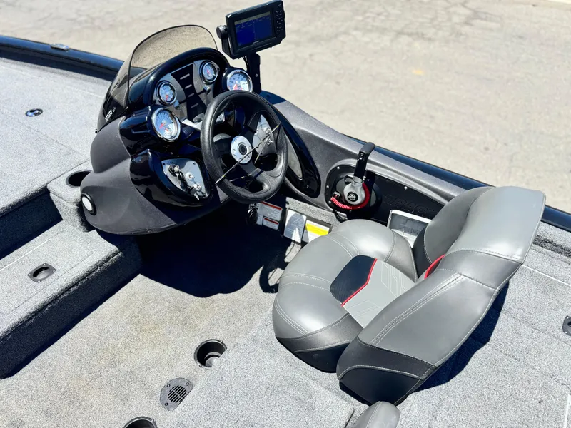 Slide: The Image of 2021 Tracker Pro Team 175 TXW boat interior with steering console and seat. - 21