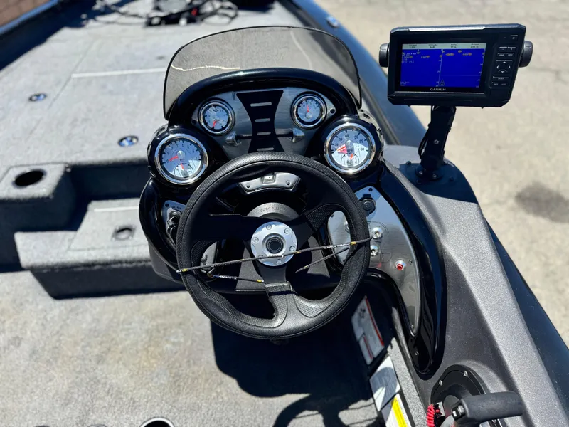 Slide: The Image of 2021 Tracker Pro Team 175 TXW boat dashboard with steering wheel and navigation display. - 22