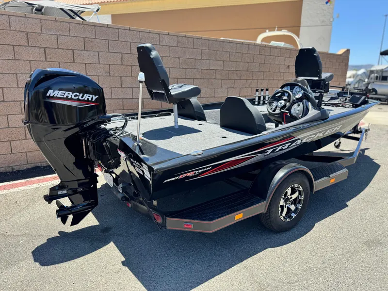 Slide: The Image of 2021 Tracker Pro Team 175 TXW boat with Mercury engine, parked outdoors. - 9
