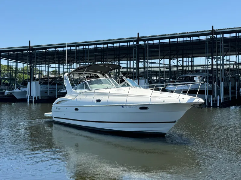 The Image of 2004 Cruisers Yachts 320 Express in marina, clear sky, calm water. - 1