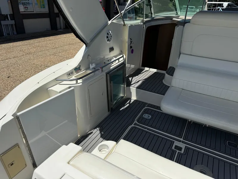 Slide: The Image of 2004 Cruisers Yachts 320 Express interior with seating and open storage compartment. - 13