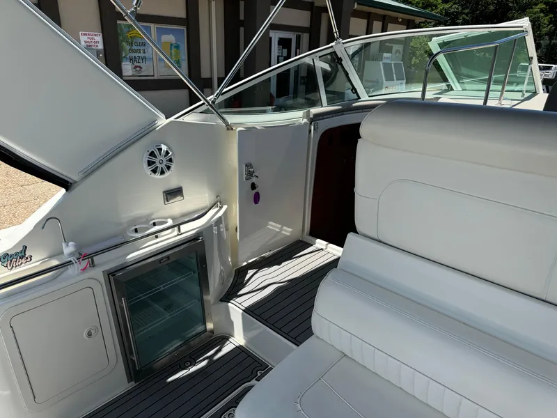 Slide: The Image of 2004 Cruisers Yachts 320 Express interior with seating and mini fridge. - 15
