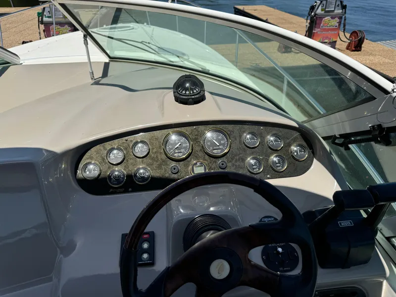 Slide: The Image of Dashboard of a 2004 Cruisers Yachts 320 Express with gauges and steering wheel. - 19
