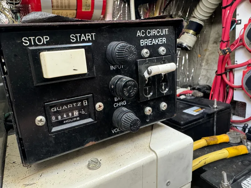Slide: The Image of Control panel of a 2004 Cruisers Yachts 320 Express with AC circuit breaker and hour meter. - 32