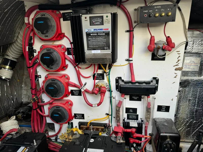 Slide: The Image of Electrical panel of a 2004 Cruisers Yachts 320 Express, featuring battery switches and wiring. - 35