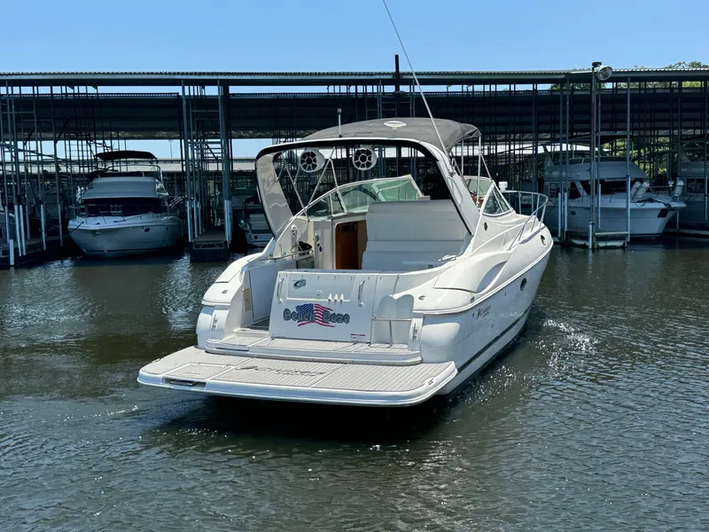 Slide: The Image of 2004 Cruisers Yachts 320 Express docked in a marina, rear view. - 4