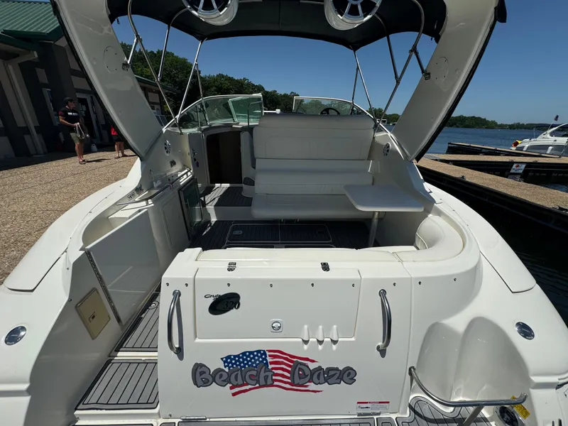 Slide: The Image of 2004 Cruisers Yachts 320 Express boat docked, featuring spacious seating and "Beach Daze" decal. - 11