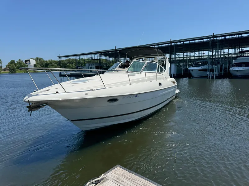 Slide: The Image of 2004 Cruisers Yachts 320 Express docked at marina on sunny day. - 2