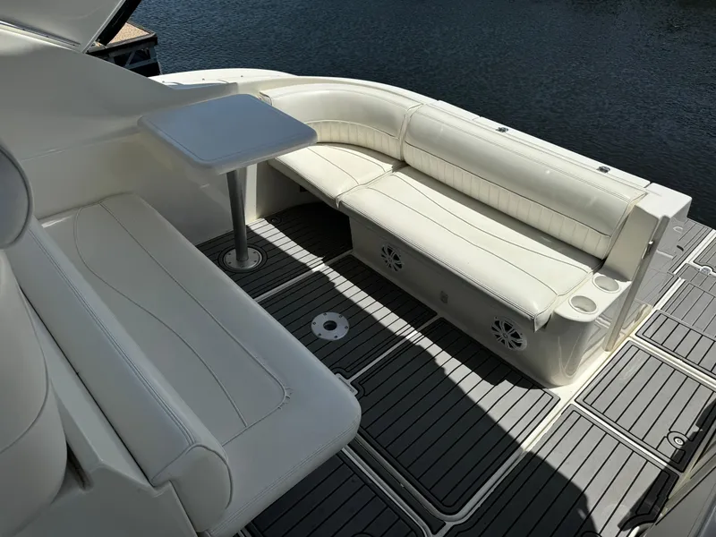 Slide: The Image of 2004 Cruisers Yachts 320 Express interior with white seating and table on deck. - 20