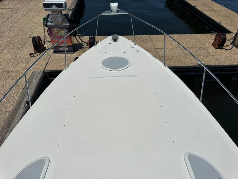 Slide: The Image of 2004 Cruisers Yachts 320 Express docked at marina, view from bow. - 23