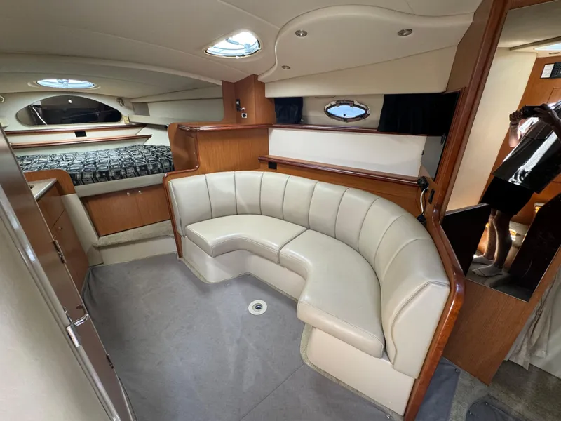 Slide: The Image of Luxurious interior of 2004 Cruisers Yachts 320 Express with plush seating and elegant wood finishes. - 25