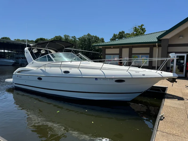 Slide: The Image of 2004 Cruisers Yachts 320 Express docked near a marina building. - 7