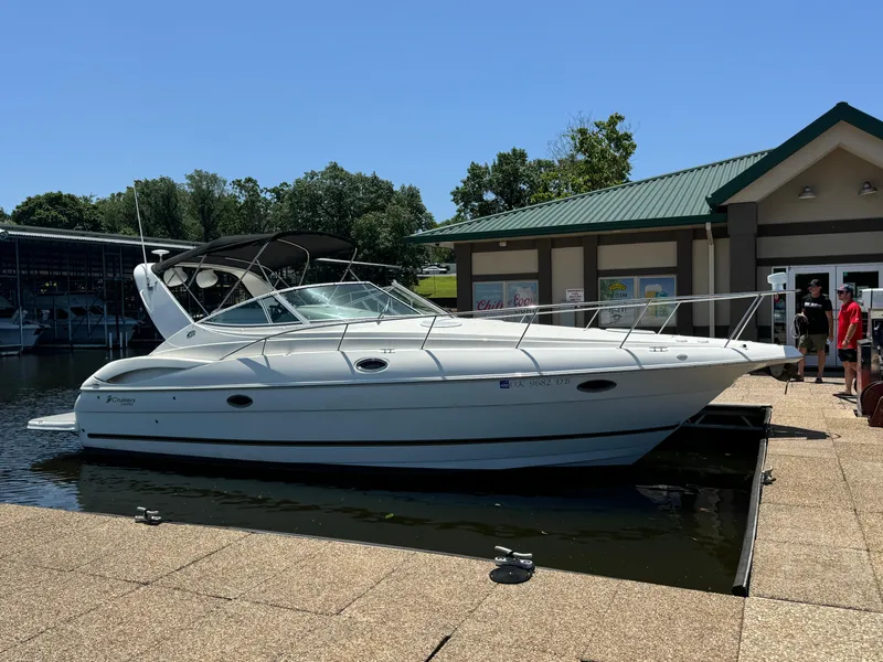 Slide: The Image of 2004 Cruisers Yachts 320 Express docked at marina under clear blue sky. - 8