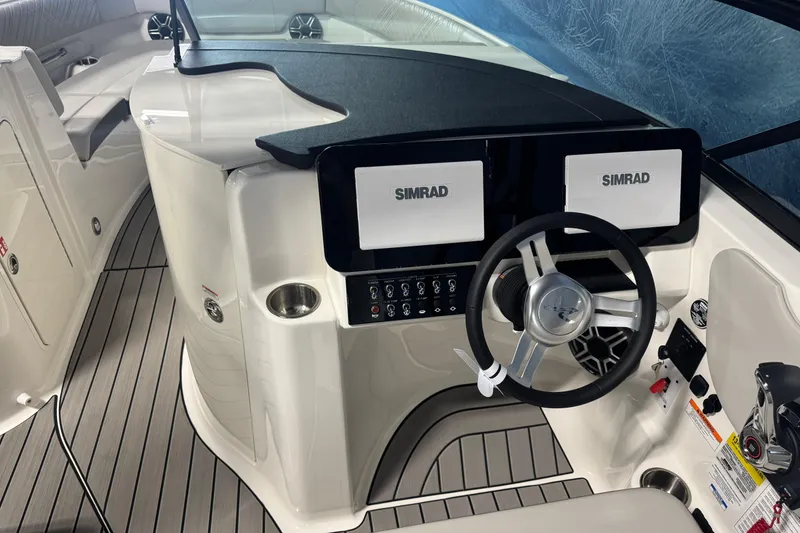 Slide: The Image of 2026 Sea Ray SDX 230 boat cockpit with dual Simrad displays and modern steering wheel. - 13