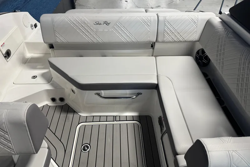 Slide: The Image of 2026 Sea Ray SDX 230 boat interior with white seating and gray flooring. - 8