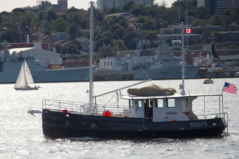The Image of Custom 2012 Steel Trawler on water, with cityscape and ships in background. - 0