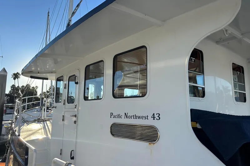 Slide: The Image of Custom 2012 Steel Trawler, Pacific Northwest 43, docked with clear sky background. - 15