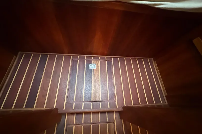 Slide: The Image of Wooden interior flooring of a 2012 Custom Steel Trawler boat cabin. - 28