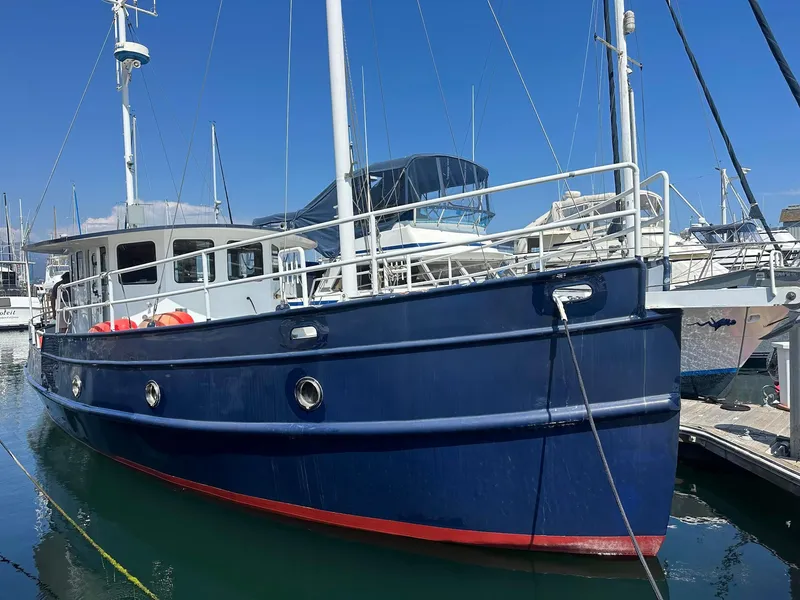 Slide: The Image of Blue 2012 Custom Steel Trawler docked at marina under clear sky. - 3