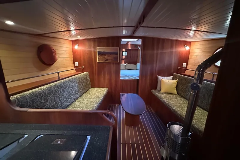 Slide: The Image of Luxurious 2012 Custom Steel Trawler interior with wood paneling and cozy seating area. - 30
