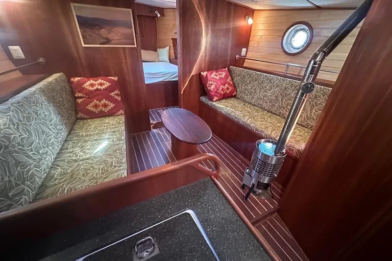 Slide: The Image of Interior of 2012 Custom Steel Trawler with cozy seating and wood paneling. - 32