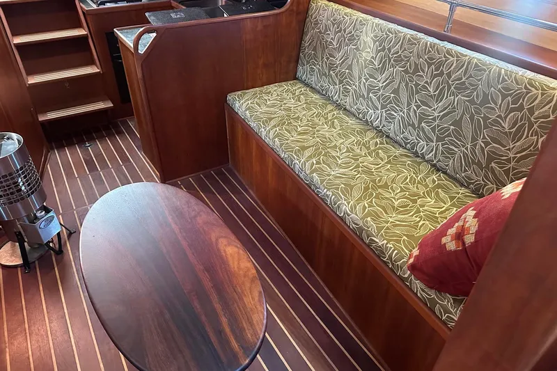 Slide: The Image of Interior of 2012 Custom Steel Trawler with wooden flooring and patterned seating. - 34