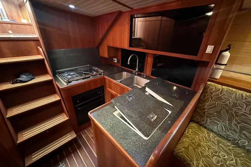 Slide: The Image of Cozy kitchen in 2012 Custom Steel Trawler with wood cabinetry and modern appliances. - 40