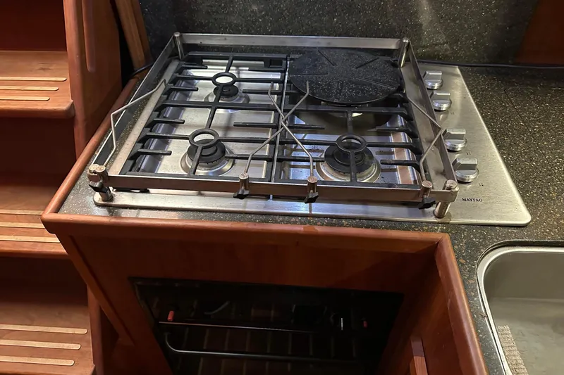 Slide: The Image of Stainless steel stove in 2012 Custom Steel Trawler kitchen, featuring multiple burners and wooden cabinetry. - 41