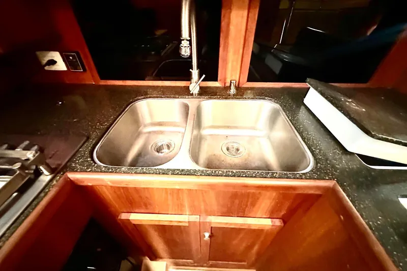 Slide: The Image of Stainless steel sink in 2012 Custom Steel Trawler kitchen with wooden cabinetry. - 42