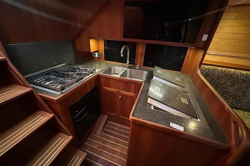 Slide: The Image of Luxurious 2012 Custom Steel Trawler kitchen with wood cabinetry and modern appliances. - 49