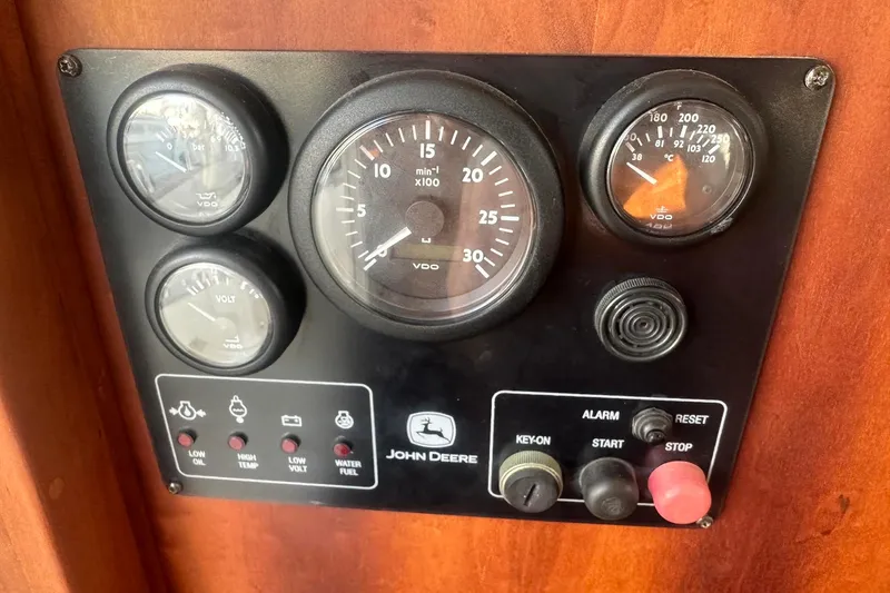 Slide: The Image of Control panel of a 2012 Custom Steel Trawler with gauges and switches. - 50