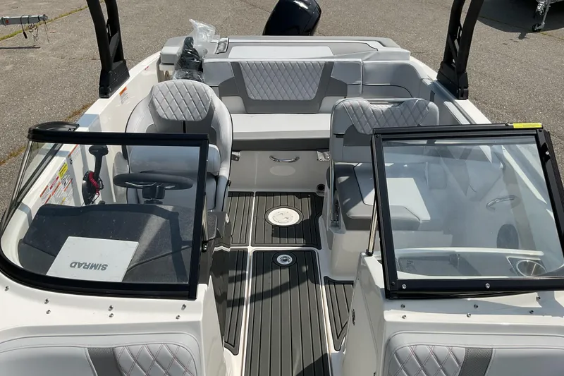 Slide: The Image of 2025 Bayliner VR5 OB boat interior with modern seating and steering wheel. - 10
