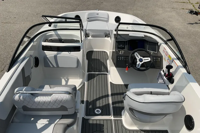 Slide: The Image of 2025 Bayliner VR5 OB boat interior with modern dashboard and seating. - 11