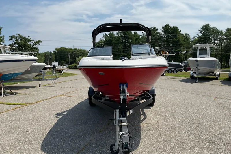 Slide: The Image of 2025 Bayliner VR5 OB boat on trailer, red hull, parked outdoors. - 3