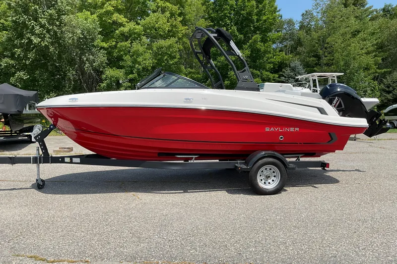 Slide: The Image of 2025 Bayliner VR5 OB boat in vibrant red on a trailer, parked outdoors. - 5