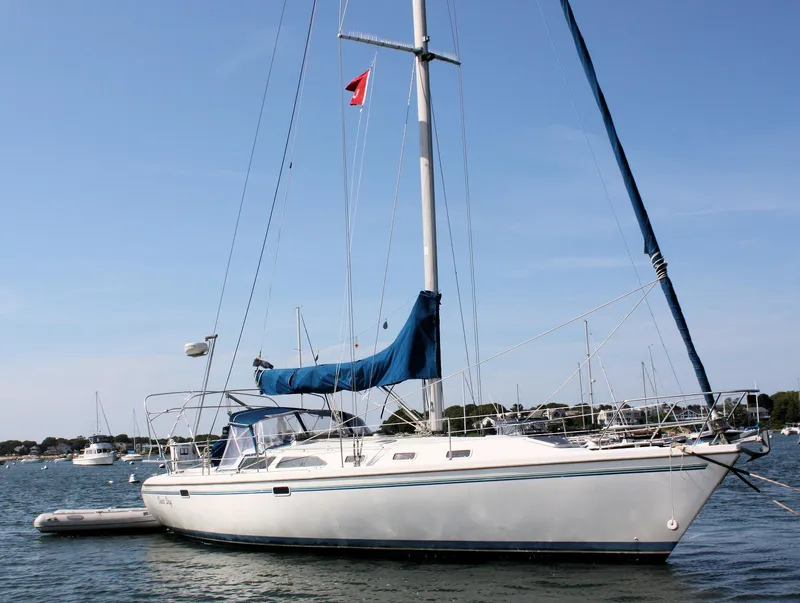 The Image of 1998 Catalina 42 MkII sailboat anchored in calm waters under a clear blue sky. - 0