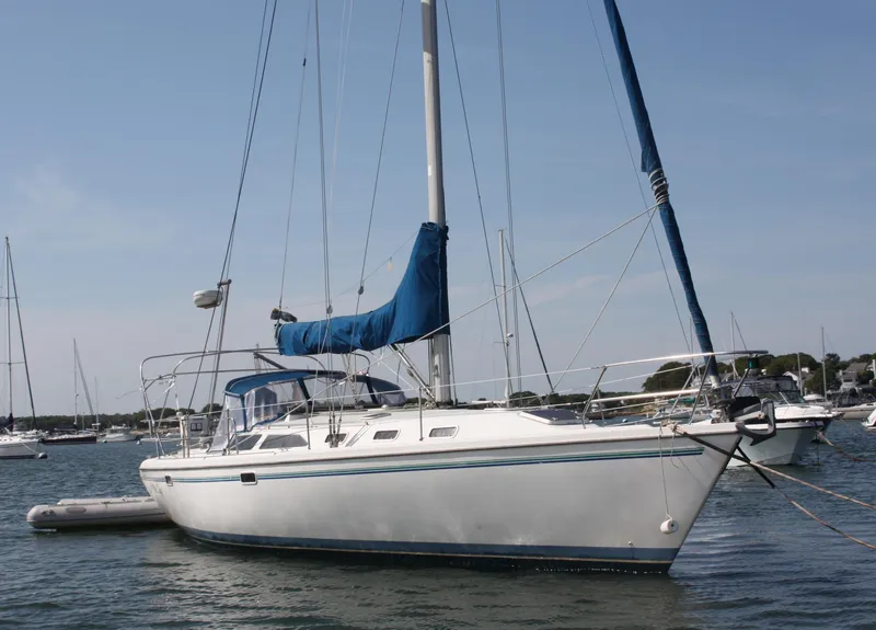 Slide: The Image of 1998 Catalina 42 MkII sailboat anchored in a calm harbor. - 1