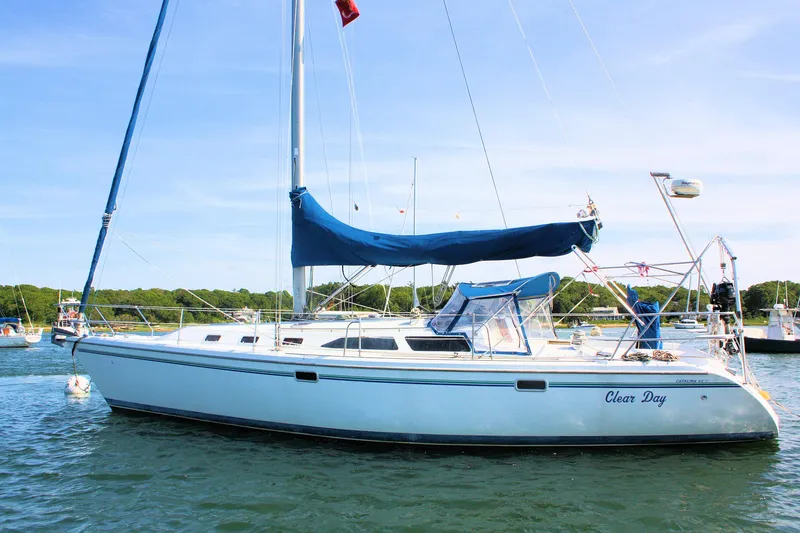 Slide: The Image of 1998 Catalina 42 MkII sailboat named "Clear Day" anchored in a scenic harbor. - 14