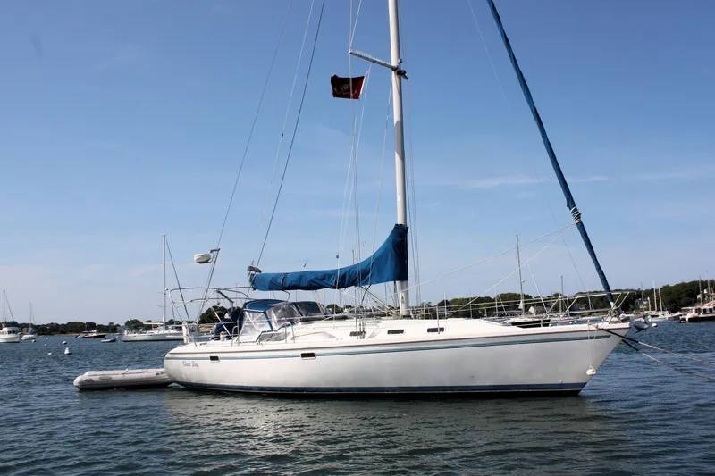 Slide: The Image of 1998 Catalina 42 MkII sailboat anchored in a serene harbor. - 2