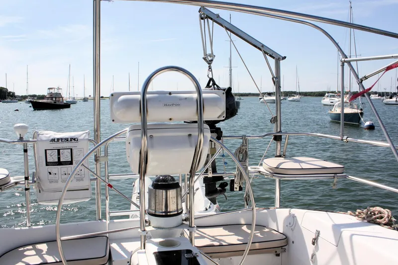 Slide: The Image of Cockpit view of a 1998 Catalina 42 MkII sailboat in a marina with other boats. - 21