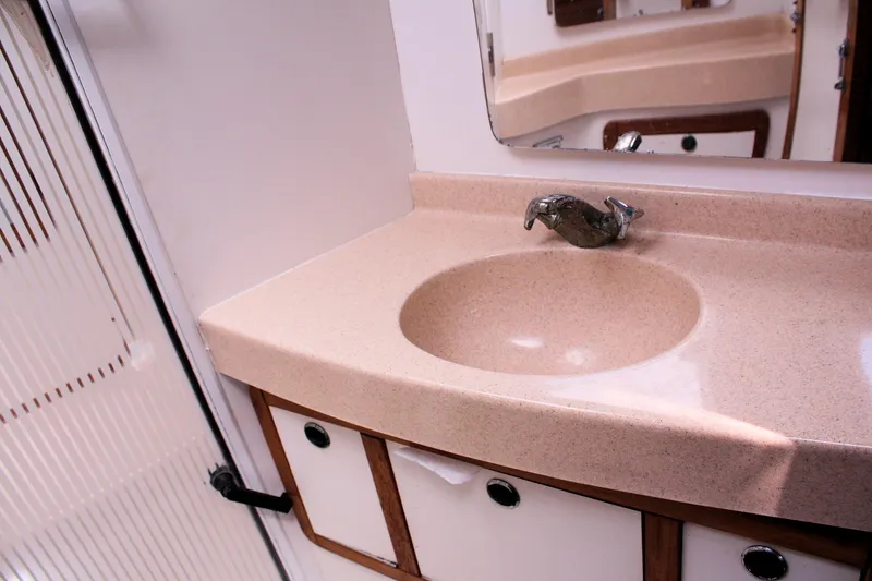 Slide: The Image of Bathroom sink area in a 1998 Catalina 42 MkII yacht, featuring a beige countertop. - 28