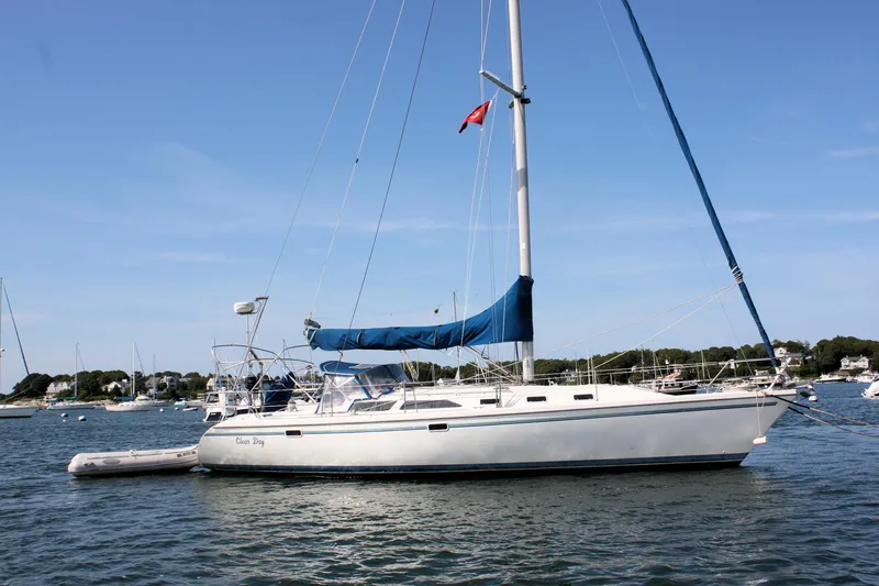 Slide: The Image of Sailboat Catalina 42 MkII 1998 anchored in a scenic harbor with clear skies. - 3