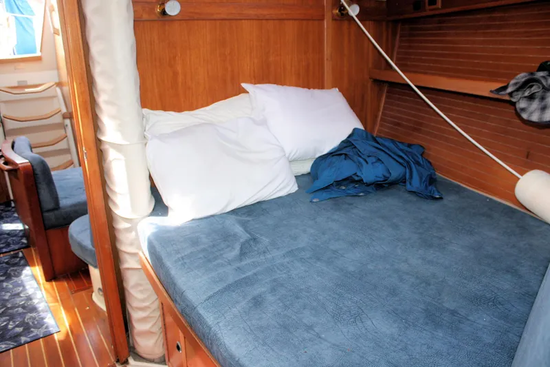 Slide: The Image of Cozy cabin interior of 1998 Catalina 42 MkII sailboat with blue bedding and wooden accents. - 33
